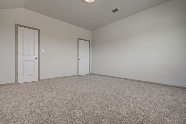 Empty room with lofted ceiling, carpet floors, and baseboards | Image 23