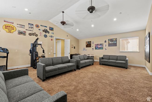 Carpeted living area with recessed lighting, baseboards, vaulted ceiling, and a ceiling fan | Image 36