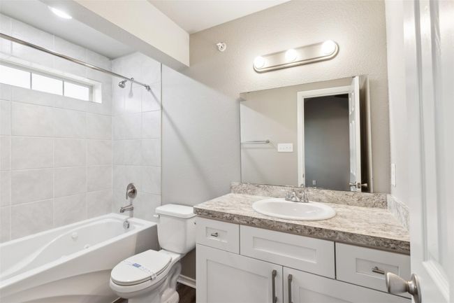 Bathroom with vanity and bathtub / shower combination | Image 13