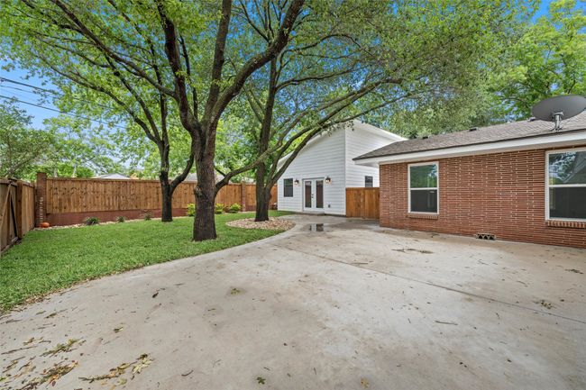 Back of house featuring french doors, a patio, brick siding, and a shingled roof | Image 30