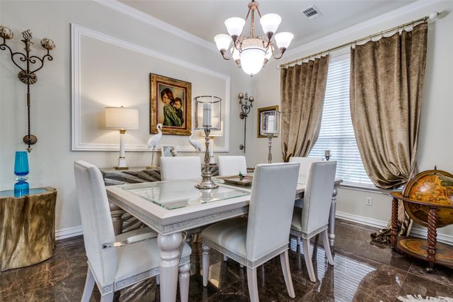 Dining area featuring chandelier, moldings, and gorgeous flooring. | Image 8