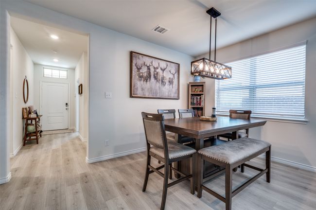 Dining area featuring baseboards, plenty of natural light, light wood-style flooring, and visible vents | Image 8
