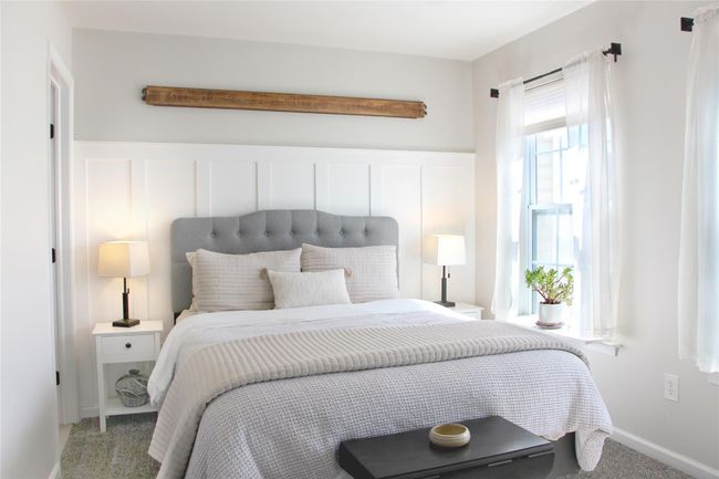 Carpeted bedroom with a decorative wall | Image 14