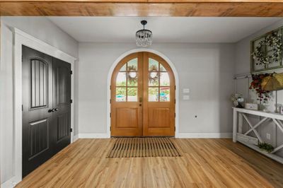 Foyer entrance featuring light hardwood / wood-style floors and a notable chandelier | Image 3