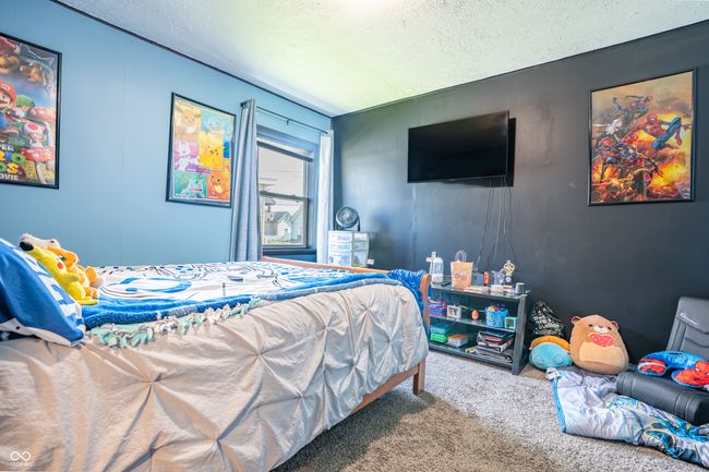 bedroom with carpet and a textured ceiling | Image 19