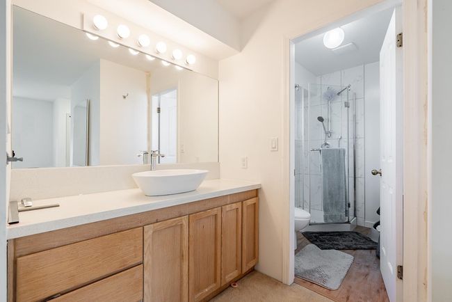 Bathroom with vanity, a shower stall, and toilet | Image 19