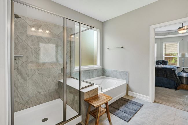Relax in this oversized tub or enjoy the walk-in tiled shower. | Image 23