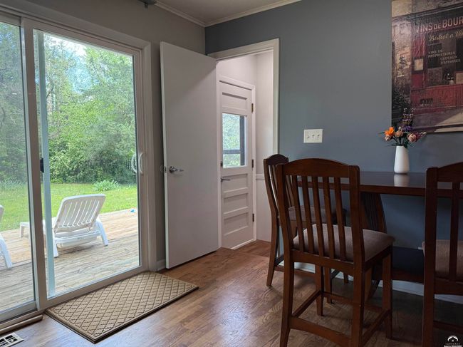 Sliding door; wood deck; Exterior basement door, LVT & wood floors; Ceiling fans & newer fixtures | Image 18