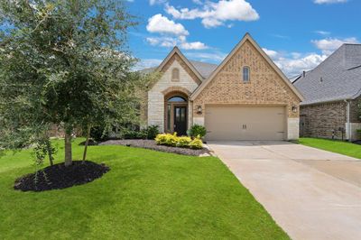 An inviting walkway greets your guests upon arrival with beautiful greenery and arched covered entry, DIVINE! | Image 2