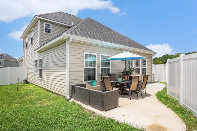 Fenced backyard with a patio | Image 25