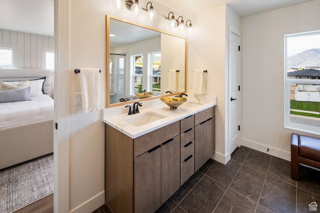 Bathroom with ensuite bath, baseboards, double vanity, and marble finish floors | Image 19