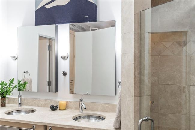 Bathroom featuring double vanity and a stall shower | Image 28