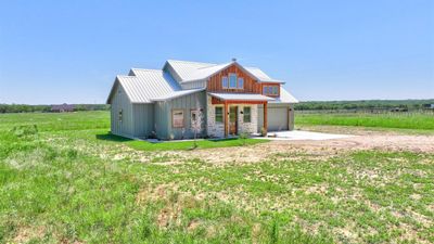 View of front of property with a garage and a front lawn | Image 2