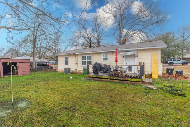 Back of house featuring central AC unit, a yard, and fence | Image 18