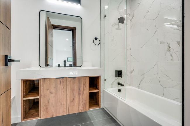Bathroom featuring vanity, shower / washtub combination, and tile patterned floors | Image 27