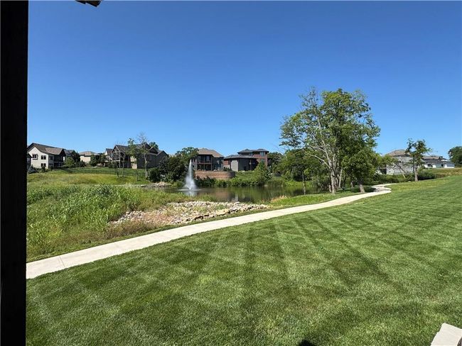 View of green lawn with a residential view and a water view | Image 13