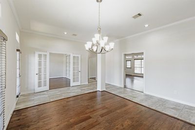 Open dining area with adjacent library/study flows to kitchen and living area. | Image 2