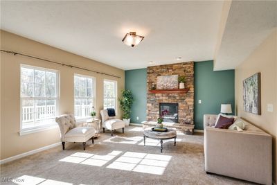 Great room with a stone fireplace and new carpet and lots of natural light | Image 2