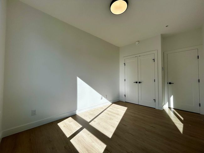 Unfurnished bedroom featuring a closet, wood finished floors, and baseboards | Image 10