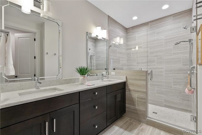 Full bathroom featuring double vanity, a stall shower, a sink, and recessed lighting | Image 23