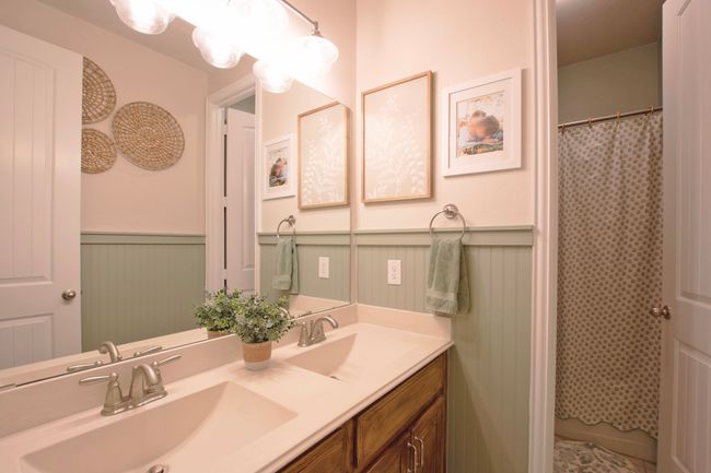 Bathroom with a sink, a wainscoted wall, and double vanity | Image 31