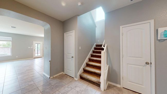 Stairway with arched walkways, baseboards, and tile patterned flooring | Image 12