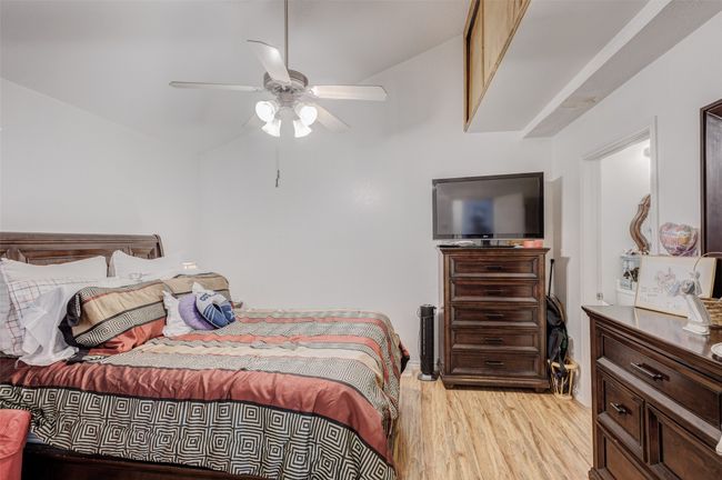 Bedroom with ceiling fan and light wood-style flooring | Image 21