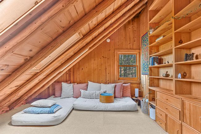 Bedroom with wood ceiling, carpet floors, wood walls, and vaulted ceiling | Image 23