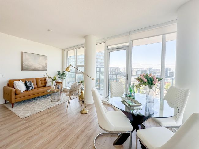 Dining space featuring a wall of windows, healthy amount of natural light, light wood-style floors, and a view of city | Image 9