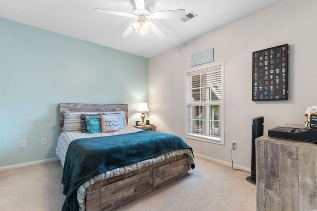 Bedroom with carpet floors, baseboards, and ceiling fan | Image 17