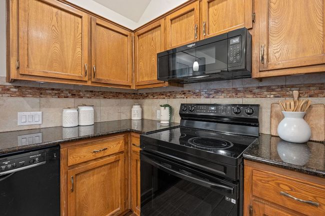 Appliances include an electric range, fridge, microwave, and dishwasher. | Image 16