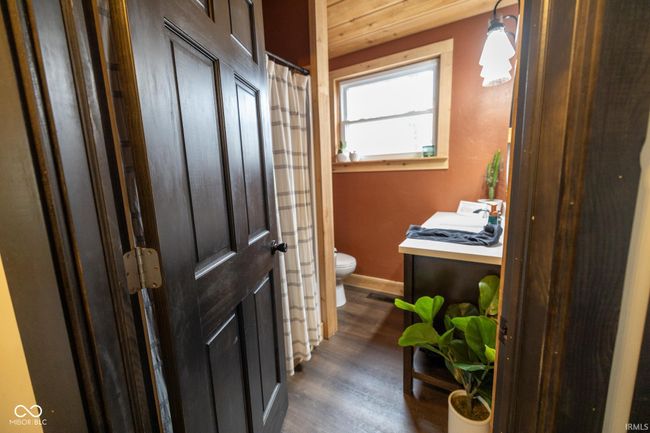 full bathroom featuring toilet, wood finished floors, vanity, and baseboards | Image 14