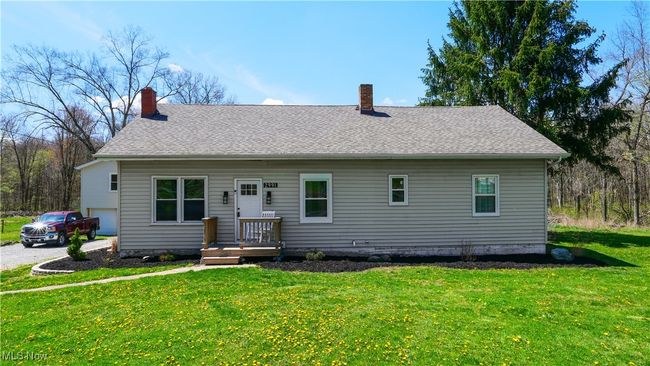 View of front of house with a front yard, a shingled roof, and a chimney | Image 24