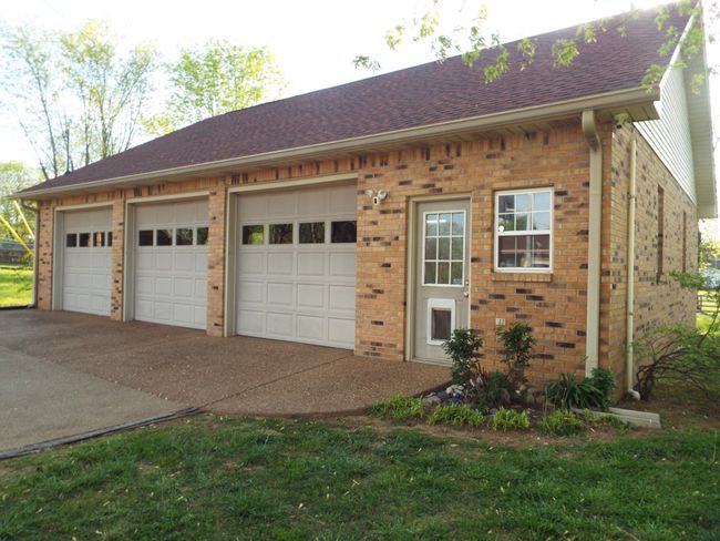3 car garage with full loft storage, half bath, insulated, gas heat & windows A/C | Image 7