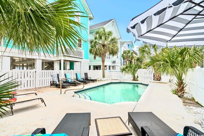 View of pool with a patio, a fenced backyard, and a fenced in pool | Image 4
