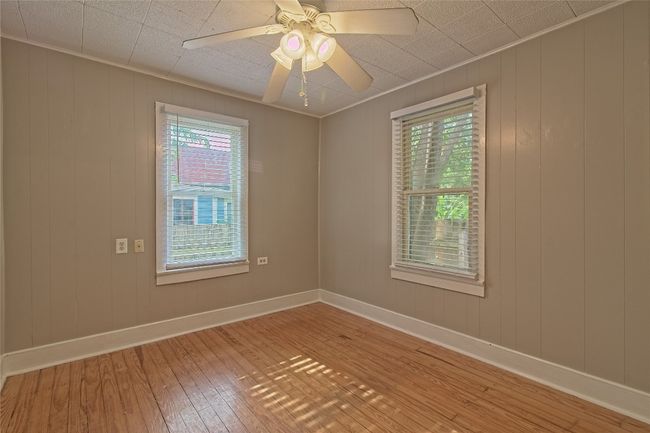 Empty room featuring light wood-style flooring and ceiling fan | Image 19