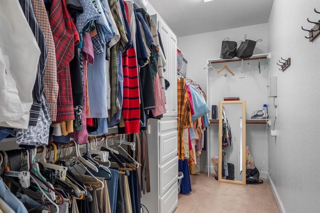 Walk in closet featuring carpet | Image 24