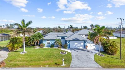 View of front facade with a front lawn and a garage | Image 2