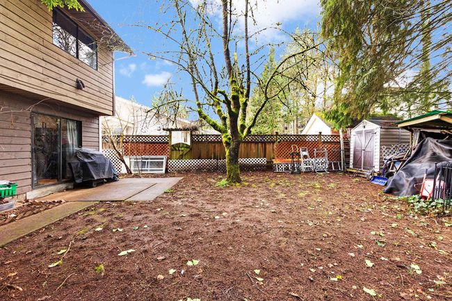 Fenced backyard featuring a storage shed and a patio | Image 28