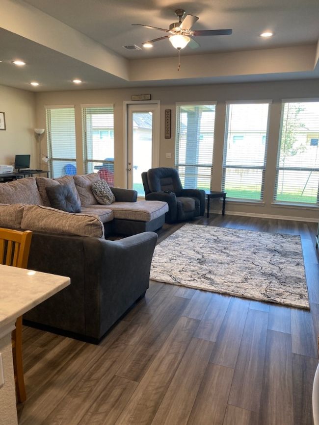 Living room featuring dark wood-style flooring, visible vents, a ceiling fan, and recessed lighting | Image 7