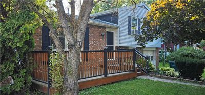 Owner is having aluminum siding replaced with cream colored vinyl siding in September | Image 1