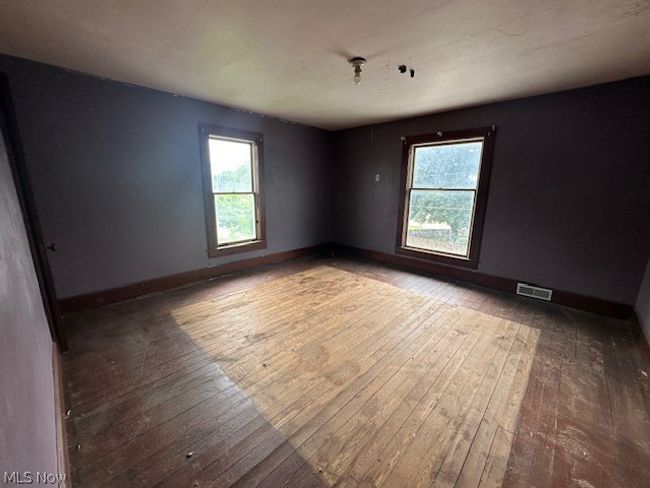 Unfurnished room with wood-type flooring | Image 11