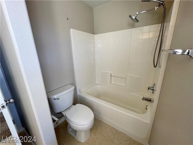 Bathroom featuring tile patterned floors, toilet, and shower / bath combination | Image 5