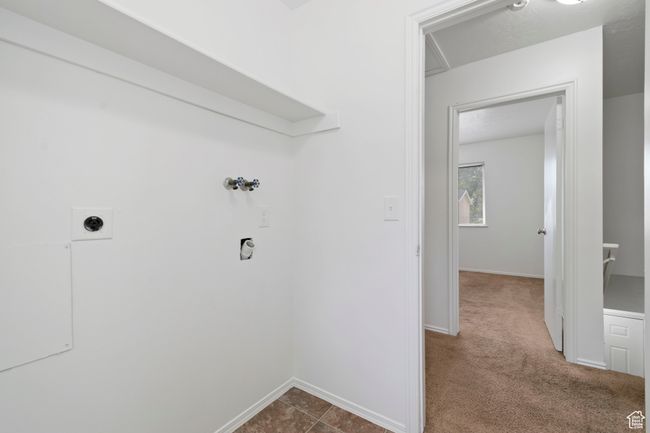 Laundry area with hookup for an electric dryer, washer hookup, and dark carpet | Image 26