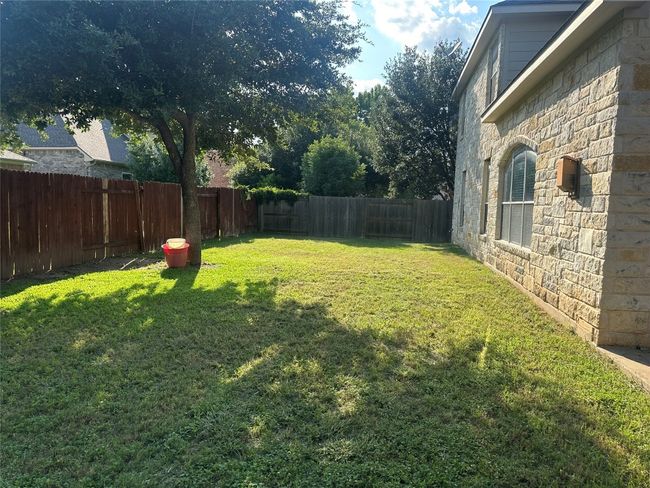 View of fenced backyard | Image 21