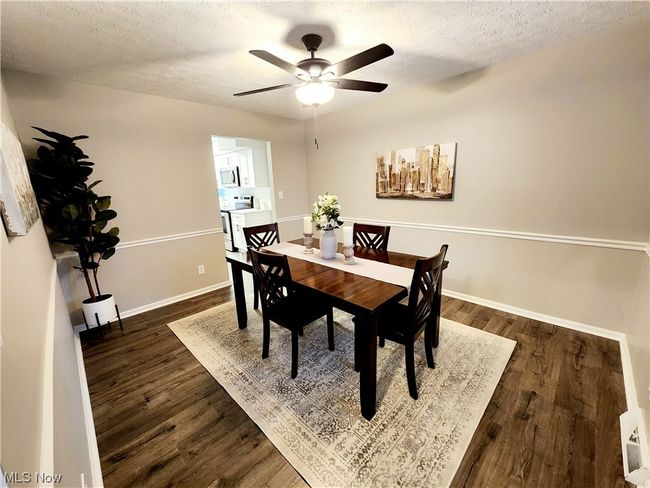 Dining area with dark hardwood / wood-style floors, ceiling fan, and a textured ceiling | Image 7