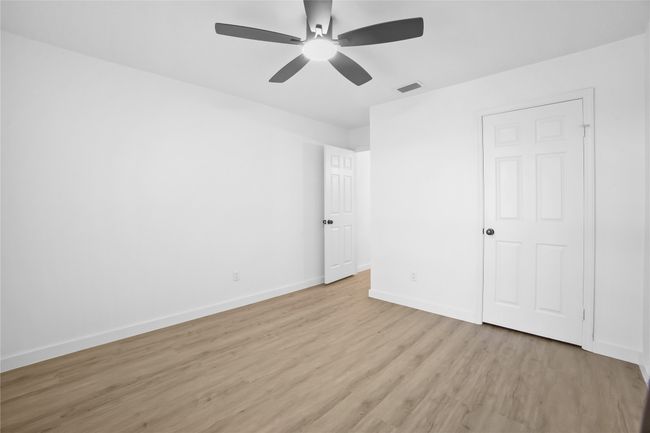 Unfurnished bedroom with light wood-style floors and a ceiling fan | Image 21