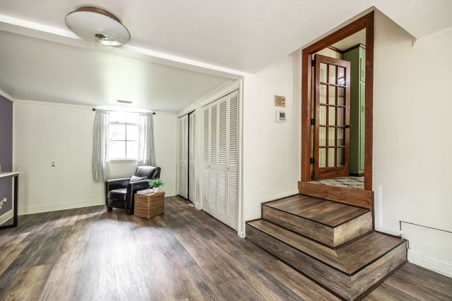 It could be an office and library or a workout room and gaming area. | Image 42