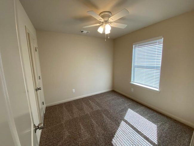 Spare room featuring carpet floors, ceiling fan, and baseboards | Image 6