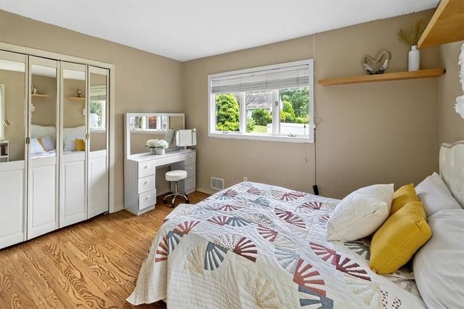 Bedroom with light hardwood / wood-style floors | Image 12